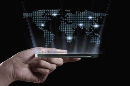 Hand holding transparent 3D smartphone. A 3D phone is a mobile phone that conveys depth perception to the viewer by employing stereoscopy or any other form of 3D depth techniques.の写真素材