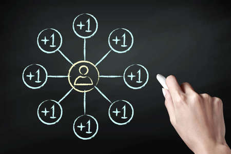 Hand holding a chalk and drawing add friend iconの写真素材