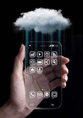 Cloud computing technology with hand and smartphone isolated on black background. Cloud computing is a general term for the delivery of hosted services over the Internet.の写真素材