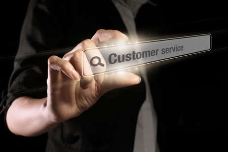 Hand showing customer service text on the virtual screenの写真素材