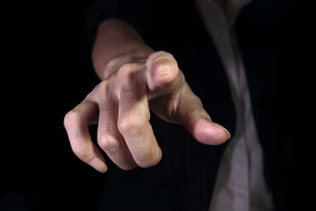 Hand pointing on blackground backgroundの写真素材