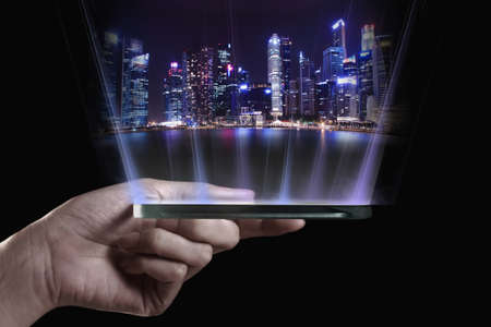 Hand holding transparent 3D smartphone. A 3D phone is a mobile phone that conveys depth perception to the viewer by employing stereoscopy or any other form of 3D depth techniques.の写真素材