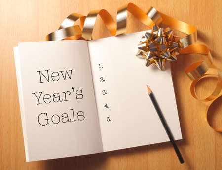 New Year's goals with gold color decorations. New Yearâ€™s goals are resolutions or promises...