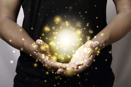 Hand showing gold color magic stars lightの写真素材