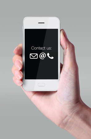 Smartphone with contact us icons on black background.