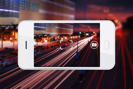 Taking night view photo with smartphone. Smartphone cameras are approaching the quality of point-and-shoot cameras.の写真素材