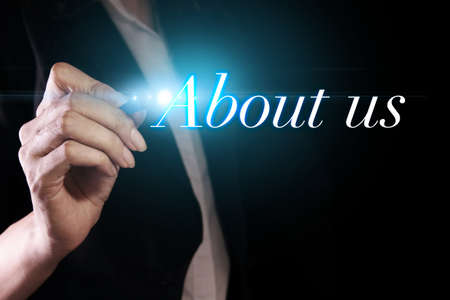 Hand writing about us on virtual screenの写真素材