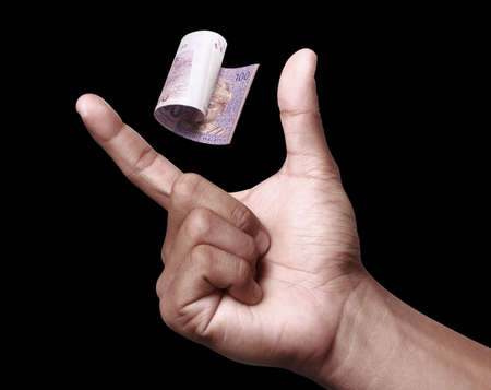 Malaysian Ringgit with hand to imply the fall or devaluation of Malaysian ringgit currencies.の写真素材
