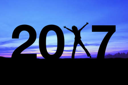 Silhouette young woman happy for 2017 new year. New year is the first day of the year in the Gregorian calendar.の写真素材