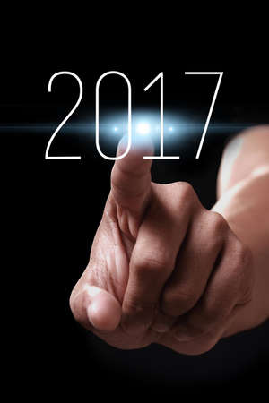 Happy new year 2017 with hand. New year is the first day of the year in the Gregorian calendar.
