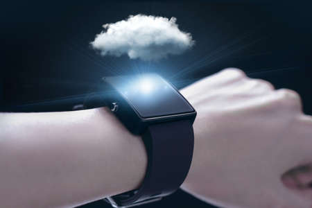 Cloud computing technology with smartwatch. A smartwatch is a wearable computing device that closely...