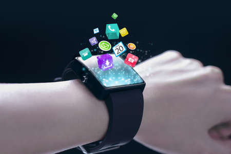 App icons with smartwatch. A smartwatch is a wearable computing device that closely resembles a wristwatch or other time-keeping device.の写真素材