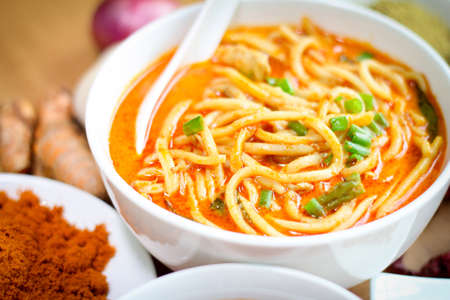 Hot and spicy curry noodle on the table. Curry noodle is a one of the popular foods in asia.の写真素材