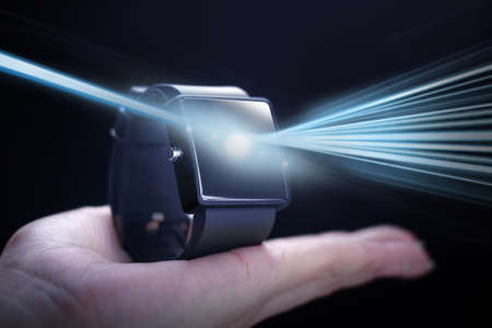Light with smartwatch. A smartwatch is a wearable computing device that closely resembles a wristwatch or other time-keeping device.の写真素材