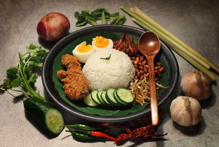 Nasi Lemak is a rice dish infused with coconut cream and laden with deep-fried fish or chicken wings.の写真素材