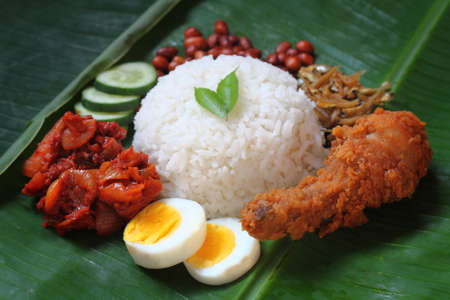 Nasi lemak is a dish that comprises rice made fragrant with coconut cream and pandan leaves.の写真素材