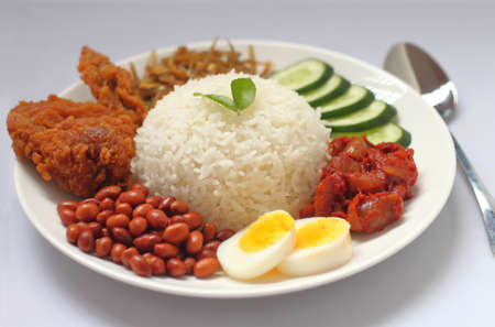 Nasi Lemak is a rice dish infused with coconut cream and laden with deep-fried fish or chicken wings.の写真素材