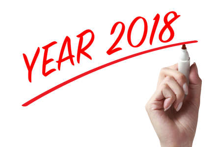 Hand holding a pen and writing year 2018. New year is the first day of the year in the Gregorian calendar.の写真素材