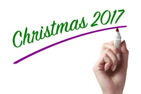 Hand holding a chalk and writing christmas 2017. Wishing you wonderful memories during this joyous season.の写真素材