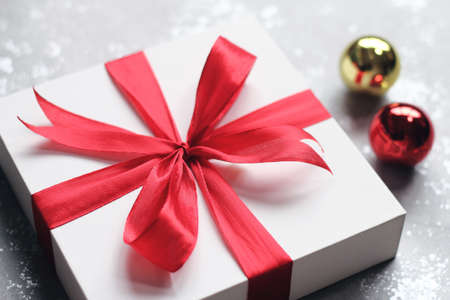 Christmas gift box with bells on simple background. Wishing you wonderful memories during this joyous season.の写真素材