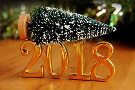 2018 gold numbers text and christmas tree decoration. New year is the first day of the year in the...