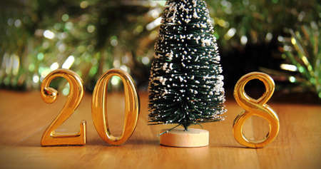 2018 gold numbers text and christmas tree decoration. New year is the first day of the year in the...