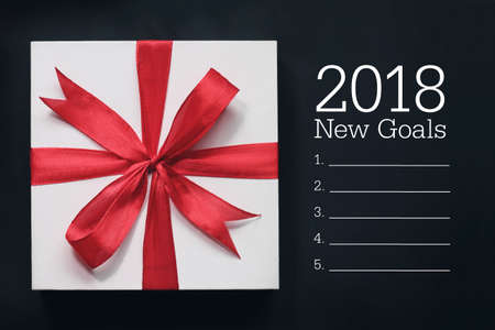 Top view of 2018 new goals with giftbox. Wishing you wonderful memories during this joyous season.