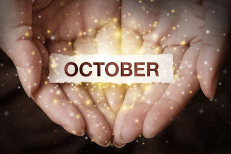 Hand showing october. May this month have a successful start and a lot of great achievements in the end!の写真素材
