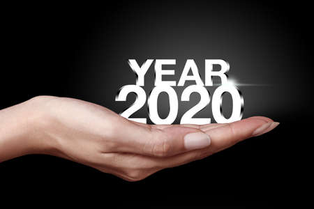 Year 2020 with hand. New year is the first day of the year in the Gregorian calendar.