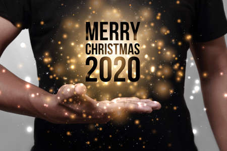 Hand showing Merry Christmas 2020. Wishing you wonderful memories during this joyous season.の写真素材