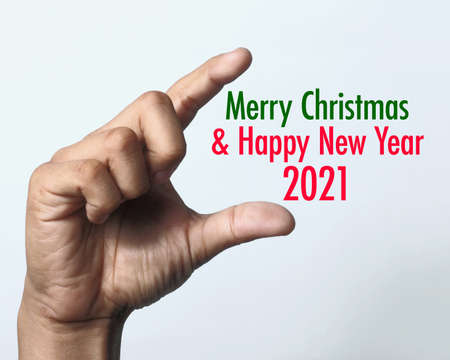 Hand showing Christmas 2021. Wishing you wonderful memories during this joyous season.の写真素材