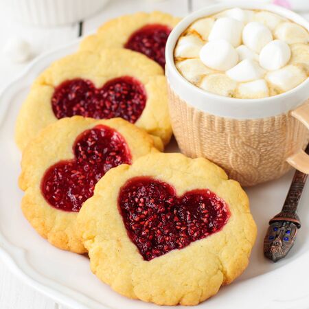 Homemade Cookies with Heart-Shaped Center and a Cup of Hot Chocolate with Marshmallowの写真素材