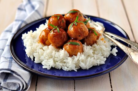 Apple cider glazed chicken meatballs on riceの写真素材