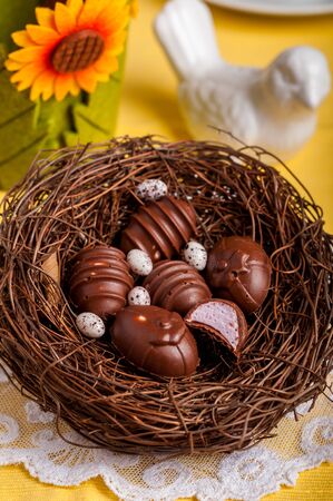 Easter Egg Shaped Chocolate Candies with Marshmallow Filling in a Nestの写真素材