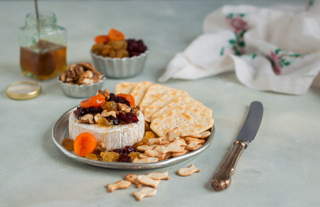 Dried Fruit (Apricots, Cranberries and Sultanas), Walnut and Honey Baked Brie with Crackersの写真素材