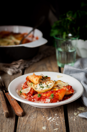 Baked Ricotta and Spinach Stuffed Conchiglioni with Tomato Sauce, copy space for your textの写真素材