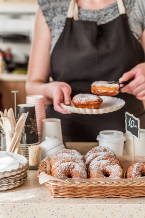 Doughnut Store Counter, Donuts with Icing Sugar in a Display Basketの写真素材