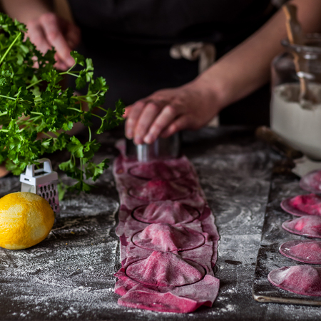 Female Making Beet Ravioli, Cutting Round Shaped Ravioliの写真素材