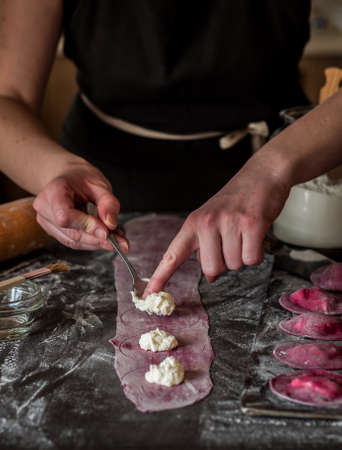 Female Making Beet Ravioli with Cottage Cheese, copy space for your textの写真素材