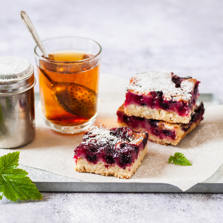 Oat and Black Currant Slice with a Glass of Tea, squareの写真素材