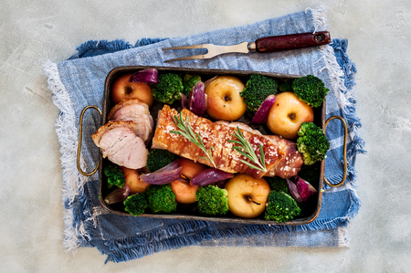 Sliced Crackling Roast Pork with Apples, Red Onion and Broccoli, copy space for your textの写真素材