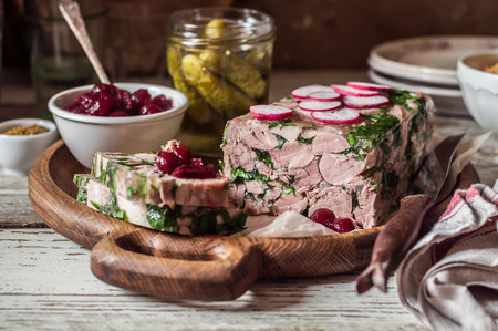 Sliced Ham Hock Jelly Terrine with Pickles and Cranberry Sauceの写真素材