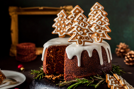 Sliced Gingerbread Cake Decorated with Spiced Christmas Cookiesの写真素材