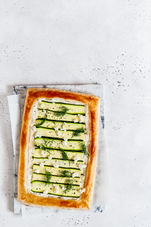 Puff Pastry Zucchini and Cheese Tart with Dill, copy space for your textの写真素材