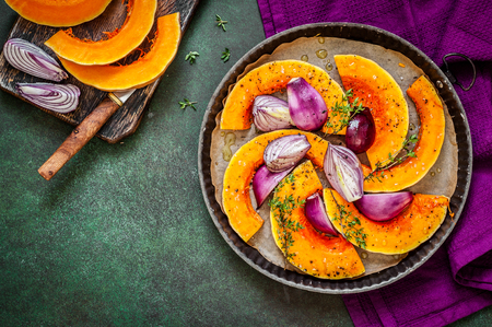 Butternut Squash Slices with Red Onions and Thyme Prepared for Roasting, copy space for your textの写真素材
