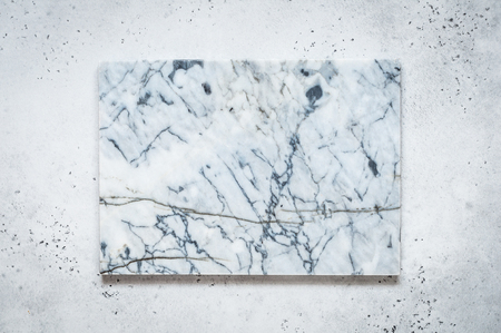 Marble Board on Light Grey Concrete Background, copy space for your textの写真素材
