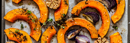 Roasted Butternut Squash Slices with Red Onions and Thyme, close up, bannerの写真素材