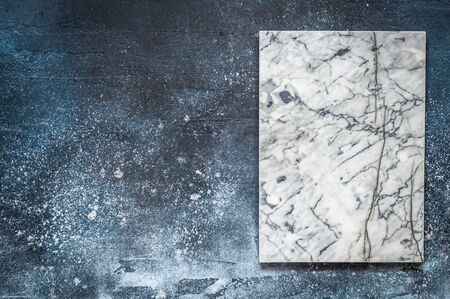 Marble Board on Dark Blue Concrete Background, copy space for your text