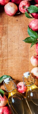 Ripe Red Apples with Leaves, Cider, Vinegar, Juice, Old Wood Background, banner, copy space for your textの写真素材