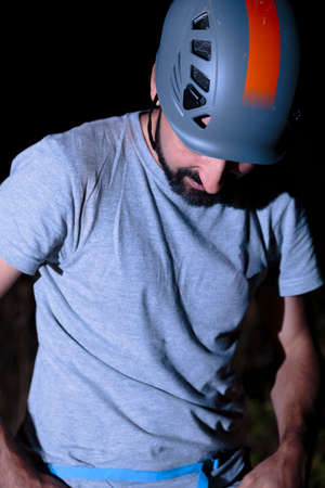 Hispanic male climber looking down before climbingの写真素材